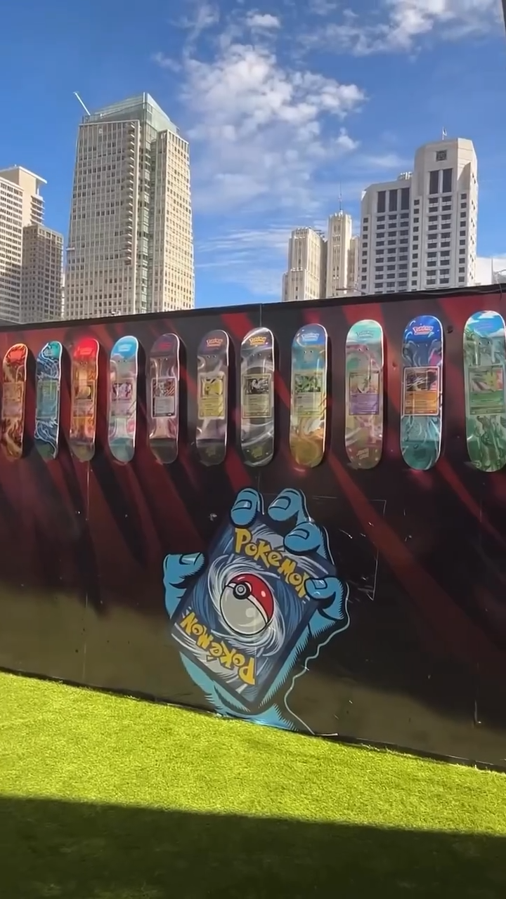 Pokémon-themed Santa Cruz blind bag skateboards displayed against a city skyline, with Pokémon artwork on the backdrop