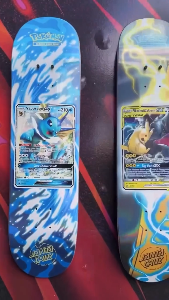 Two Pokémon-themed Santa Cruz skateboards featuring Vaporeon and Pikachu trading card graphics on their decks