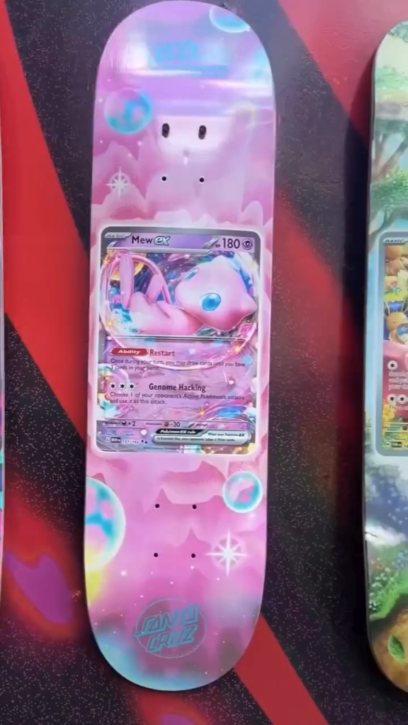 Pink Pokémon-themed skateboard deck featuring Mew ex artwork and a holographic finish