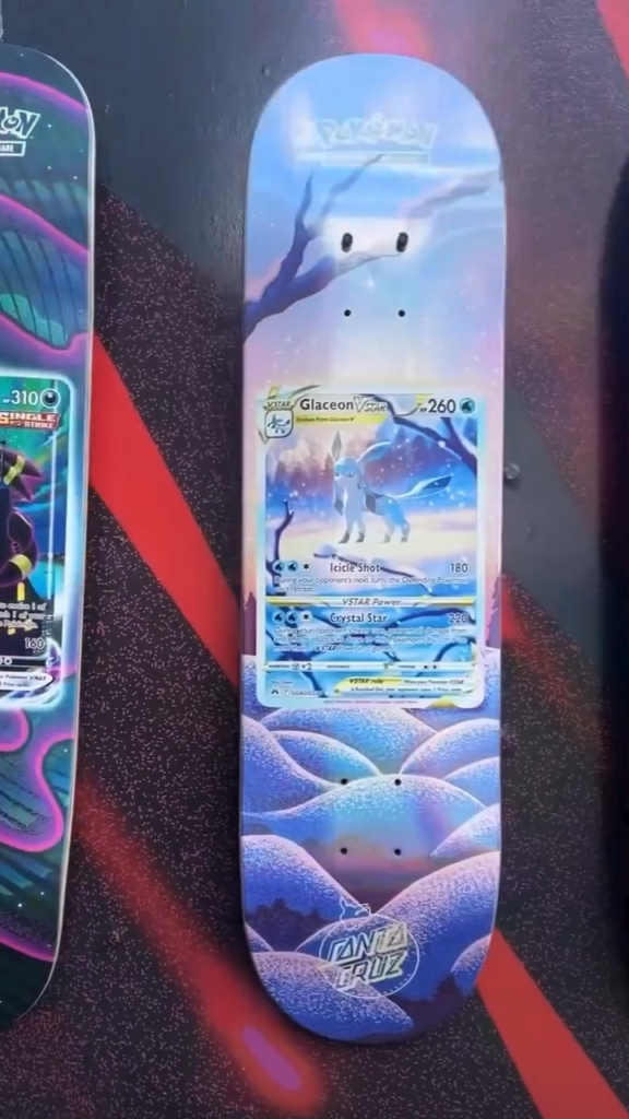 Glaceon Pokémon trading card design on a blue skateboard deck displayed against a black and red background