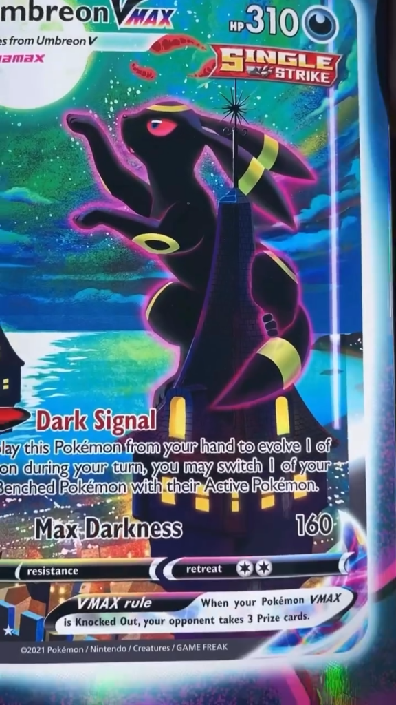 Pokémon Umbreon VMAX trading card with Dark Signal and Max Darkness attacks displayed close up