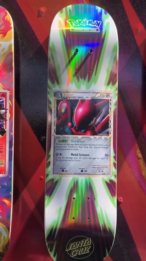 Pokémon Scizor trading card graphic on a multicolored Santa Cruz skateboard deck
