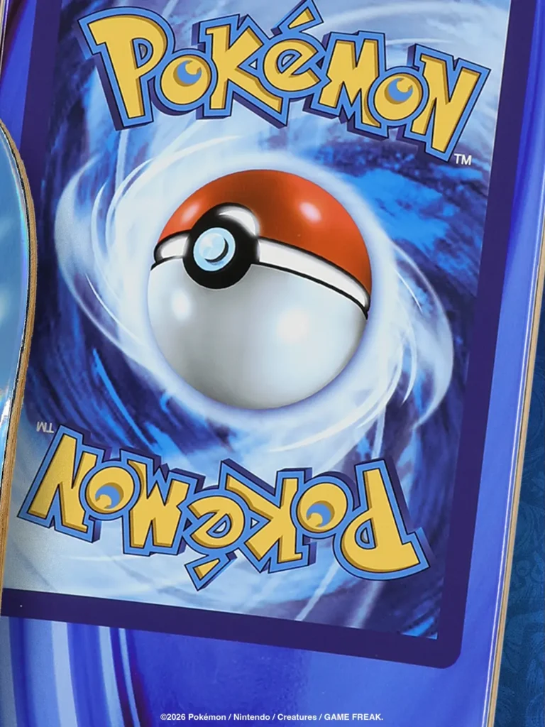 A bright blue cartoon hand grips a giant Pokémon Trade Card Game card back. Yellow “Pokémon” logos sit at the top and bottom around a red-and-white Poké Ball on a swirling blue background. Abstract red, orange, and purple light streaks fill the space behind the hand. Copyright: ©2026 Pokémon / Nintendo / Creature / GAME FREAK