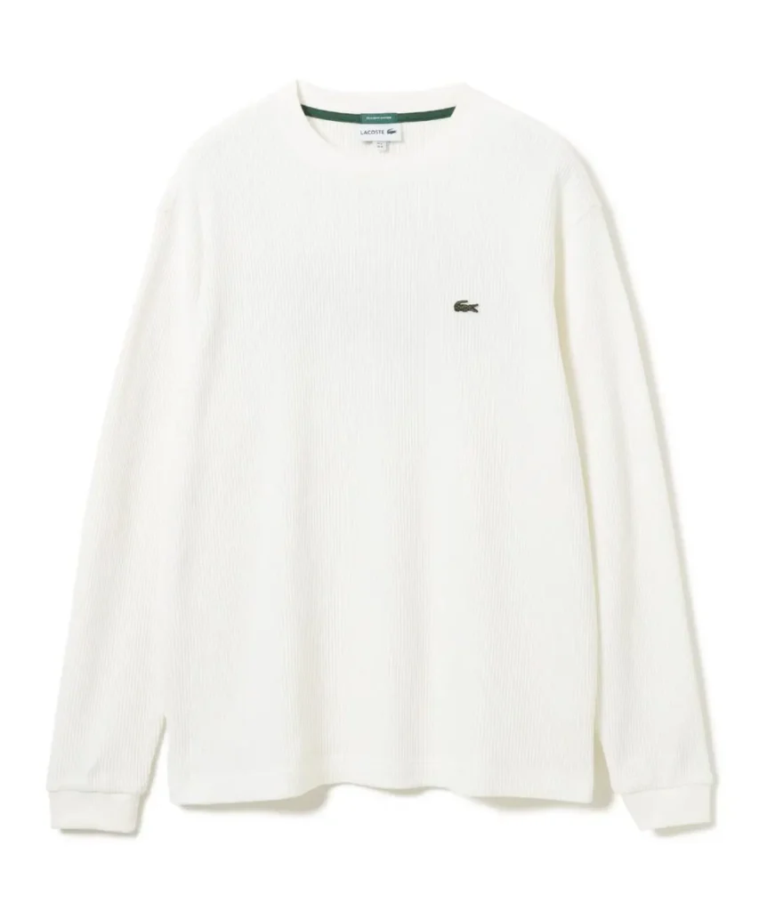 White ribbed long-sleeve Lacoste sweater with green neck trim and crocodile logo, displayed against a white background