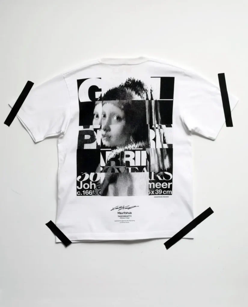 Back of a white Tee feature a large glitch-style black-and-white collage of Girl with a Pearl Earring with commemorative Mauritshuis brand below