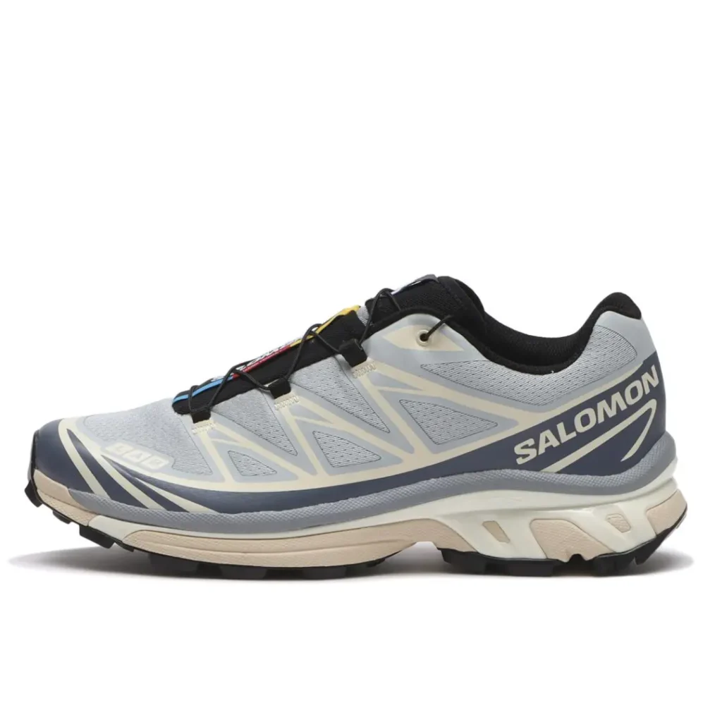 Side Profile Of Salomon XT-6 In Gray, Cream And Black On A White Background