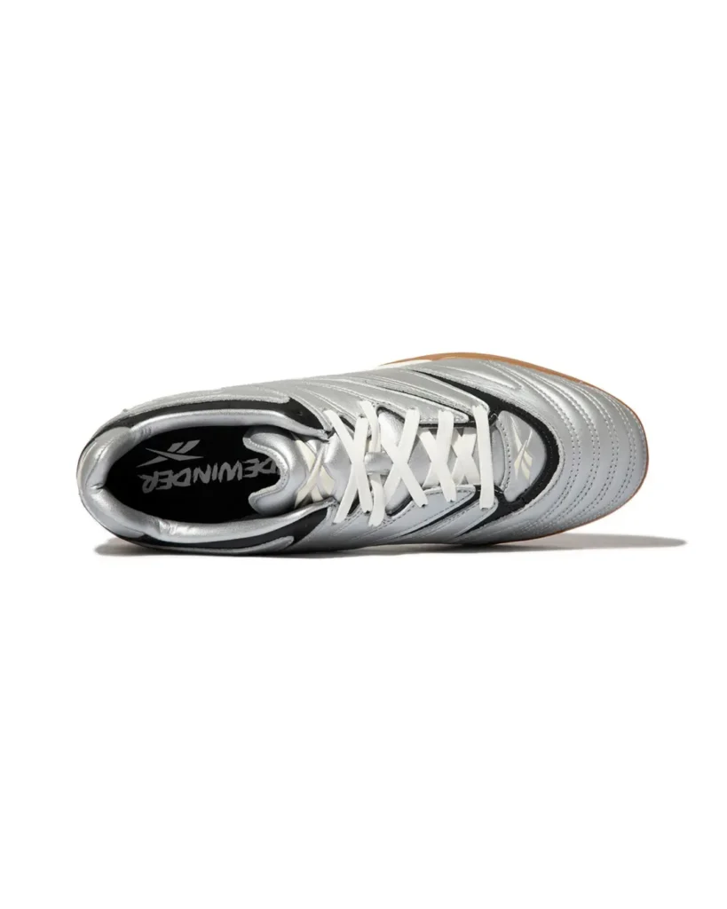 Top view of the Reebok Sidewinder 96 ID show its metallic silver upper, white laces, black detailing and Sidewinder-brand insole