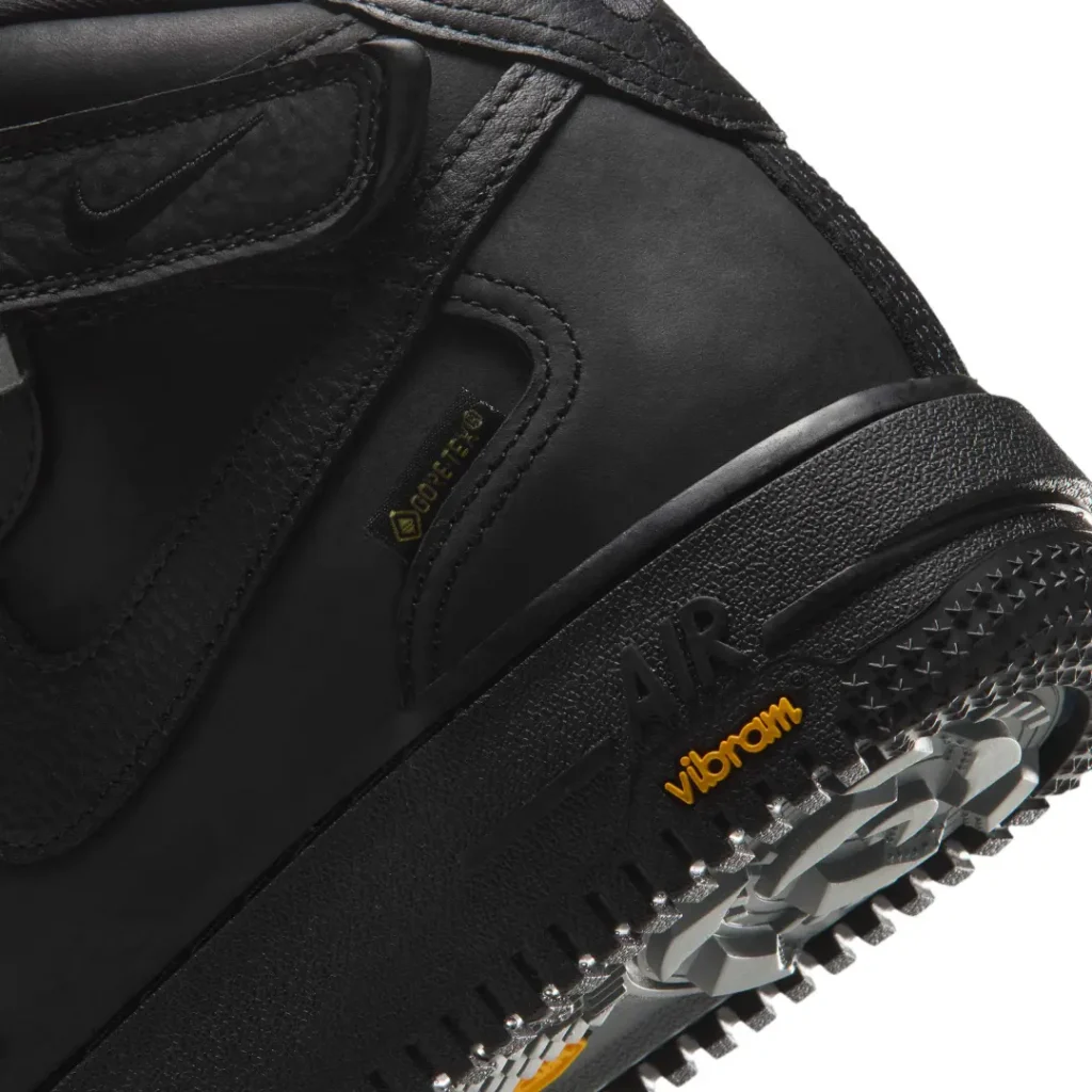 Close-up of the black Nike Air Force 1 Mid heel show GORE-TEX brand, texture midsole and Vibram outsole