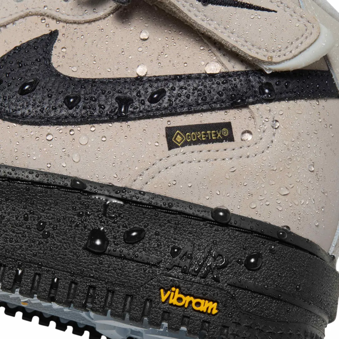 Close-Up Of Beige Nike Air Force 1 Mid GORE-TEX With Water Droplets, Black Swoosh And Vibram Outsole