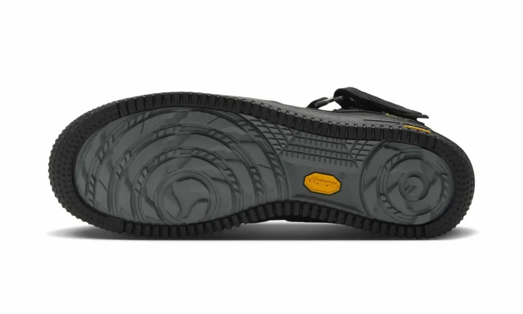 Bottom view of the black Nike Air Force 1 Mid show the rugged Vibram outsole and circular tract pattern