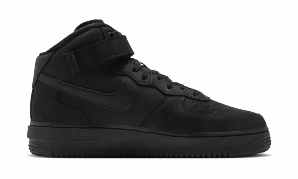 Medial side profile of the all-black Nike Air Force 1 Mid with ankle strap and tonal Swoosh