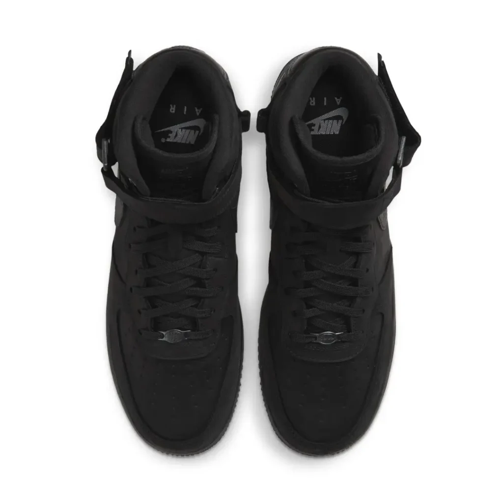 Top view of a pair of black Nike Air Force 1 Mid shoe show pad collar, ankle strap and black lace