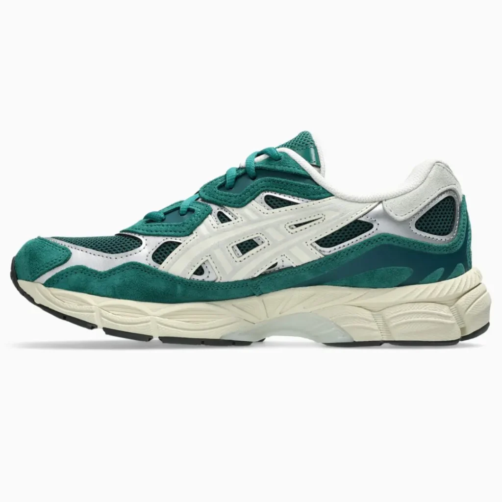 Green and white mesh sneaker with layered panels, thick cream sole, and black tread on a white background