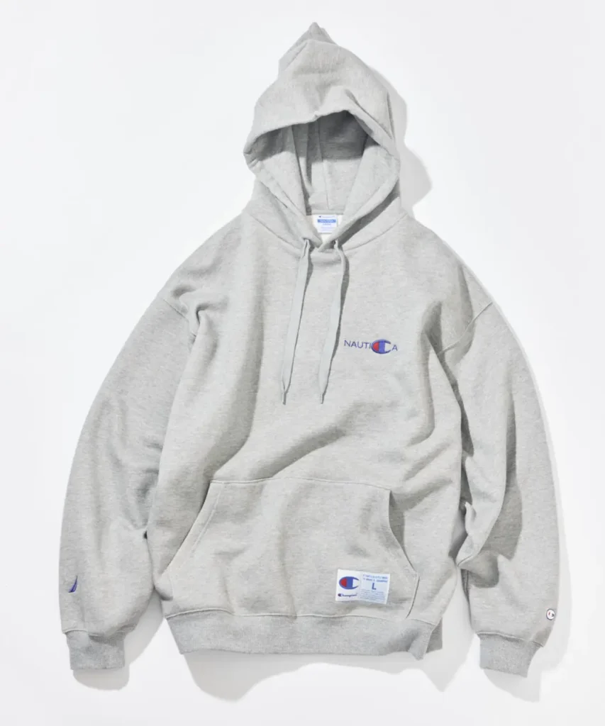 Light gray Champion x Nautica pullover hoodie feature embroider Nautica chest brand, kangaroo pocket, and collide hem label
