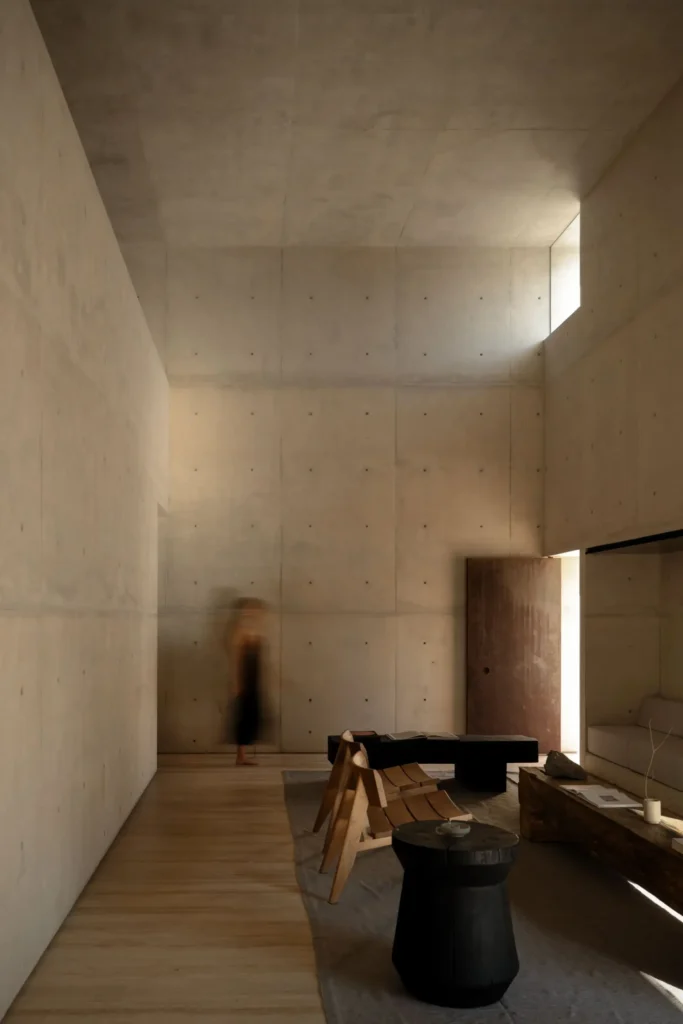 Elevate interior view overlook a min dining area with exposed concrete architecture, warm wood finish, and abundant natural daylight
