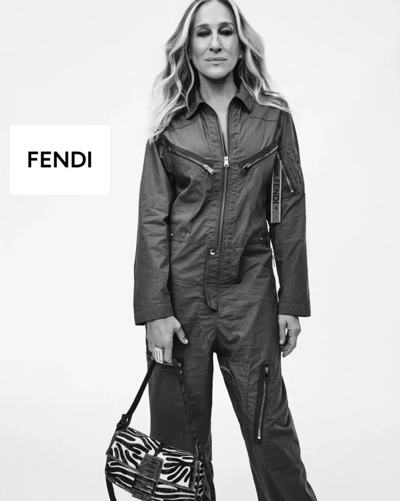 Black-And-White Fendi Portrait With Woman In Utility Jumpsuit Holdi A Pattern Baguette Bag