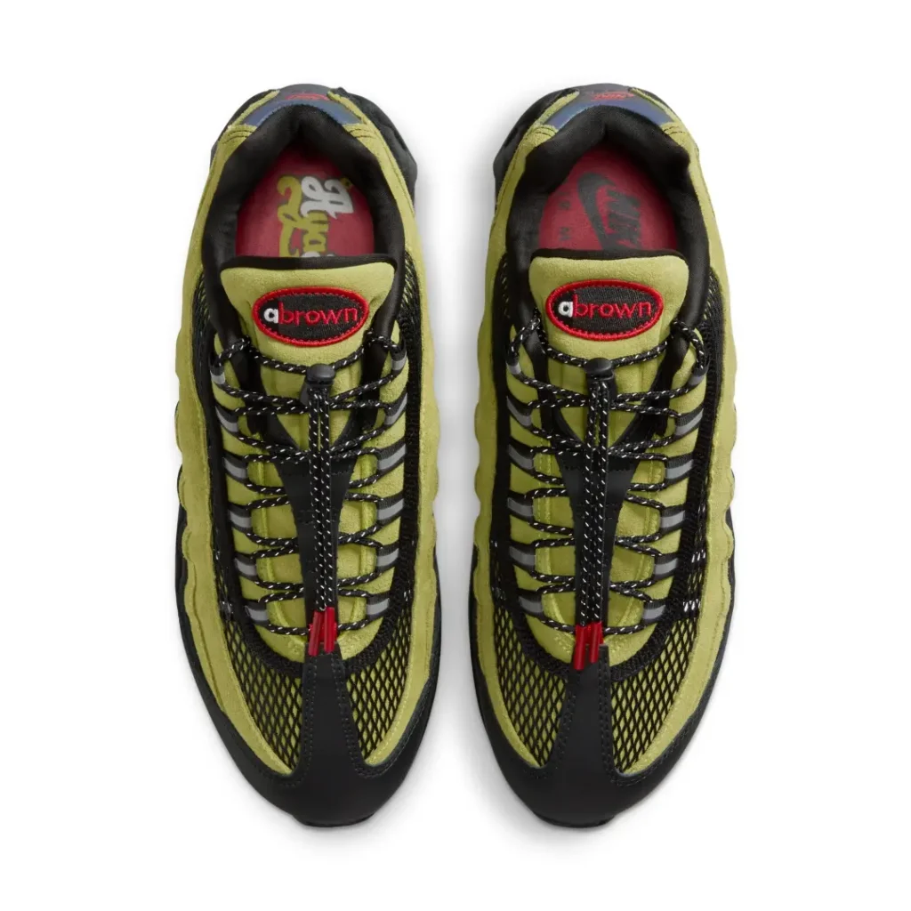 Top view of the A Ma Maniére x Nike Air Max 95 pair show olive tongue, black rope laces, mesh panel, and embroider tongue brand