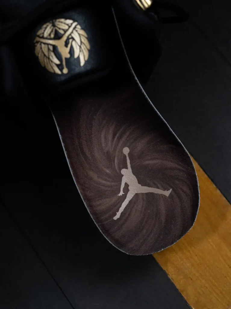 Air Jordan 12 Insole Feature A Metallic Jumpman Logo Over A Dark Swirl Graphic Pattern