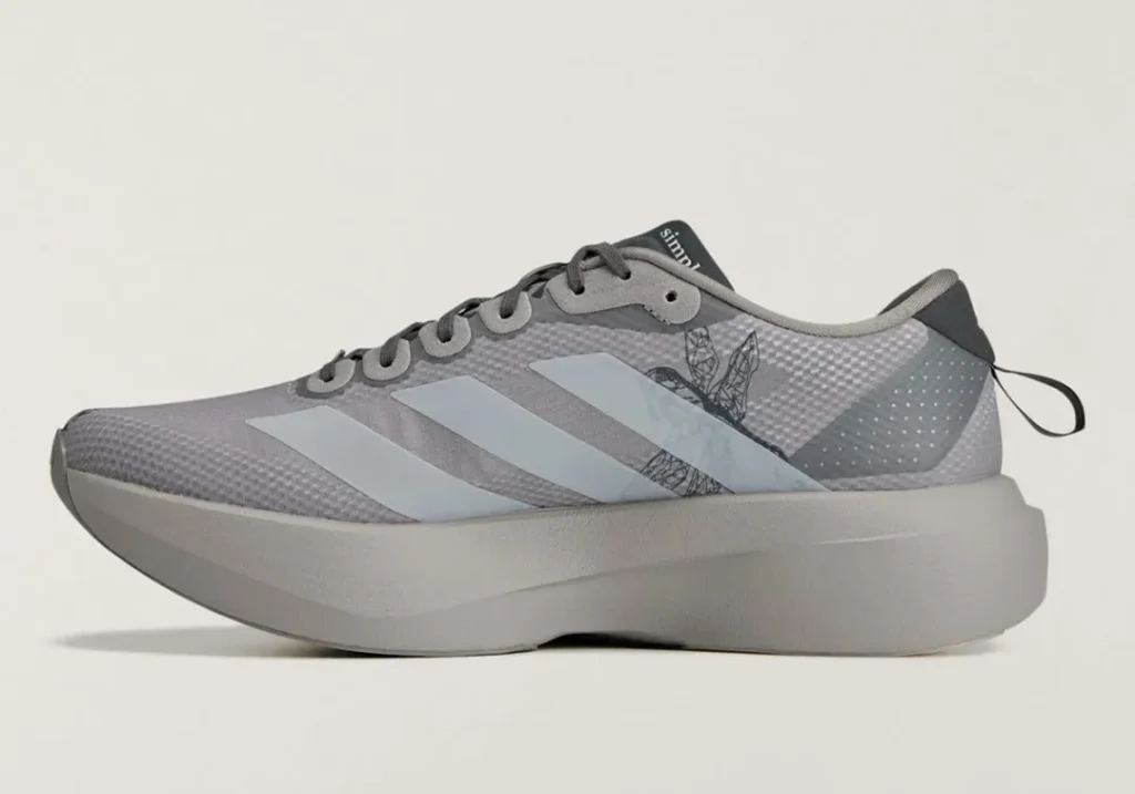 Opposite side profile of the gray adidas Adizero shoe with graphic linework, translucent stripes, and a sculpted mid