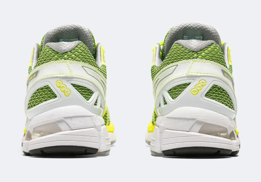 Rear view of a pair of ASICS GEL-Kayano 20 shoe show white heel support, green mesh and GEL cushion