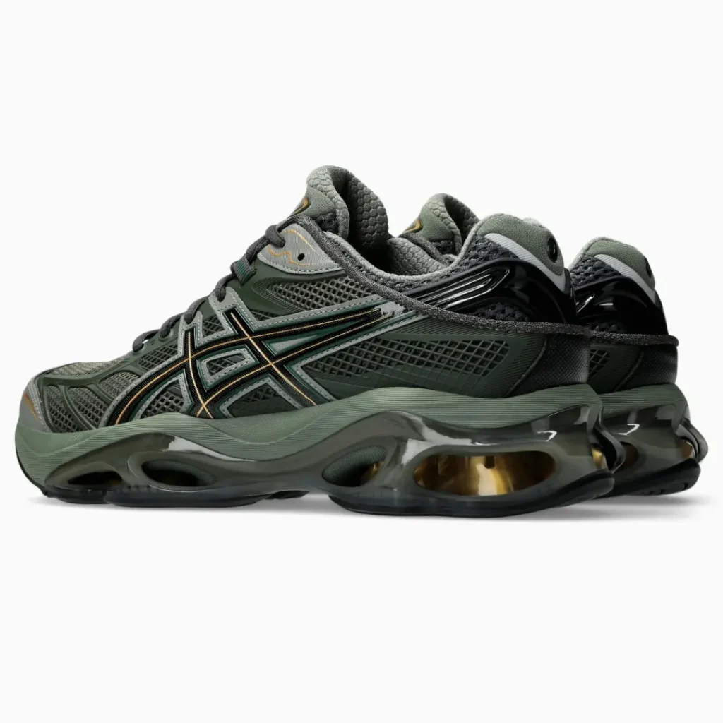 Rear-side view of a pair of olive green ASICS shoe show glossy black heel counters, layered mesh panels, and large visible cushion units with gold-toned interior