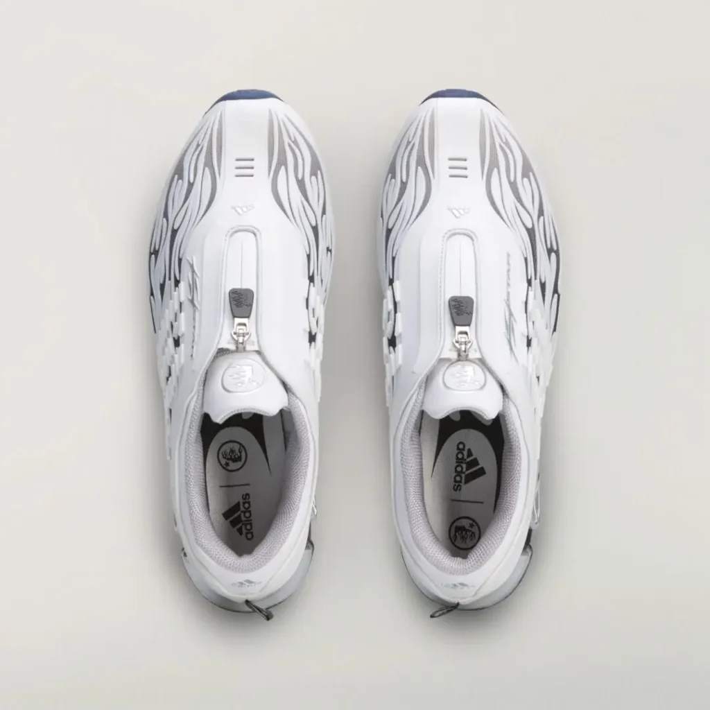 Top view of the white adidas pair featuring flame-patterned uppers, central zipper closures, gray lining, and branded insole