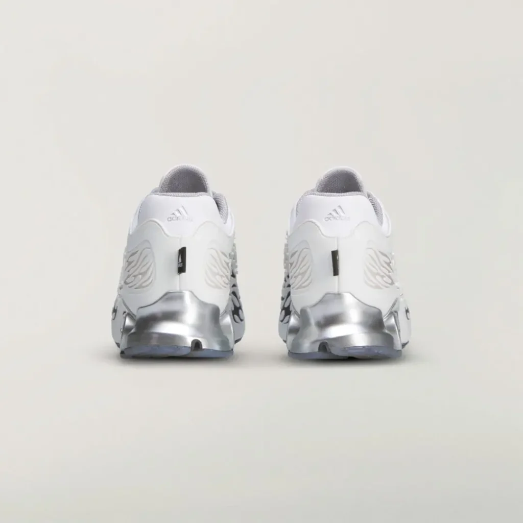 Rear view of the white adidas shoes with embossed heel branding, flame detailing, and reflective silver heel structure
