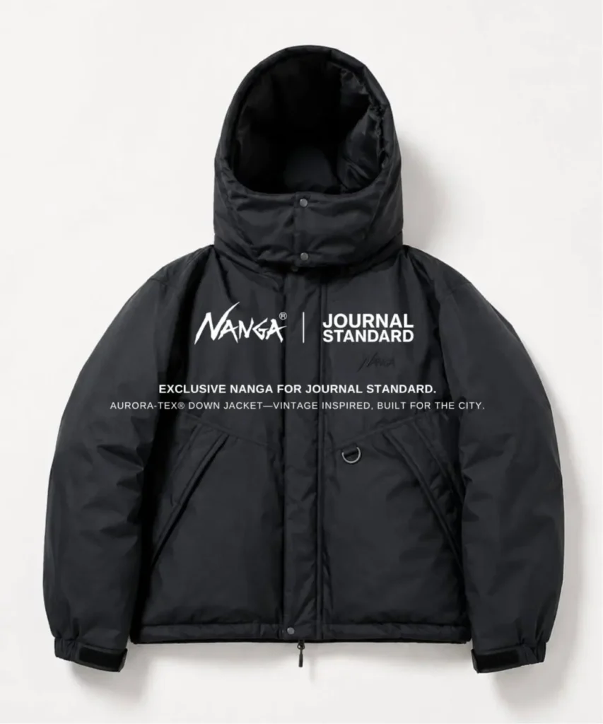 Black hooded puffer jacket with oversized collar, front pockets, and a metal D-ring, shown against white background
