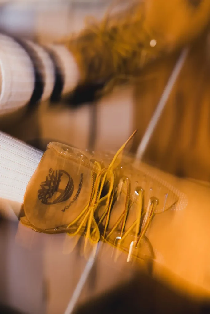 Motion-blur close-up of a Timberland x Kvi Baba wheat boot feature stud panel and brand tongue