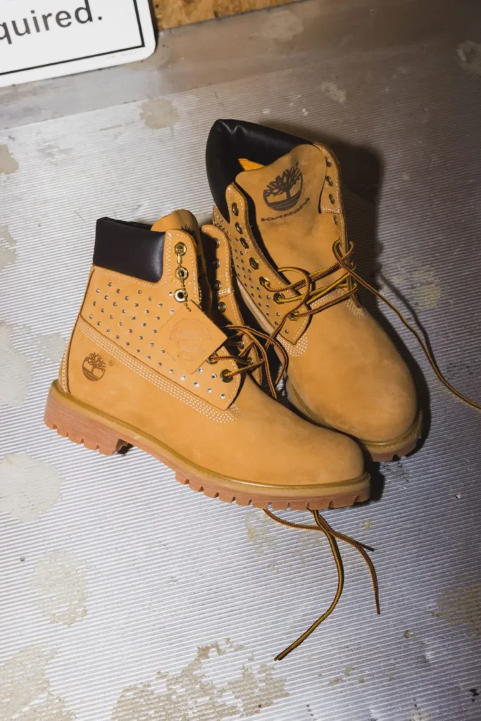 Pair of wheat Timberland x Kvi Baba boot with metal stud detail, black pad collar and loose two-tone lace
