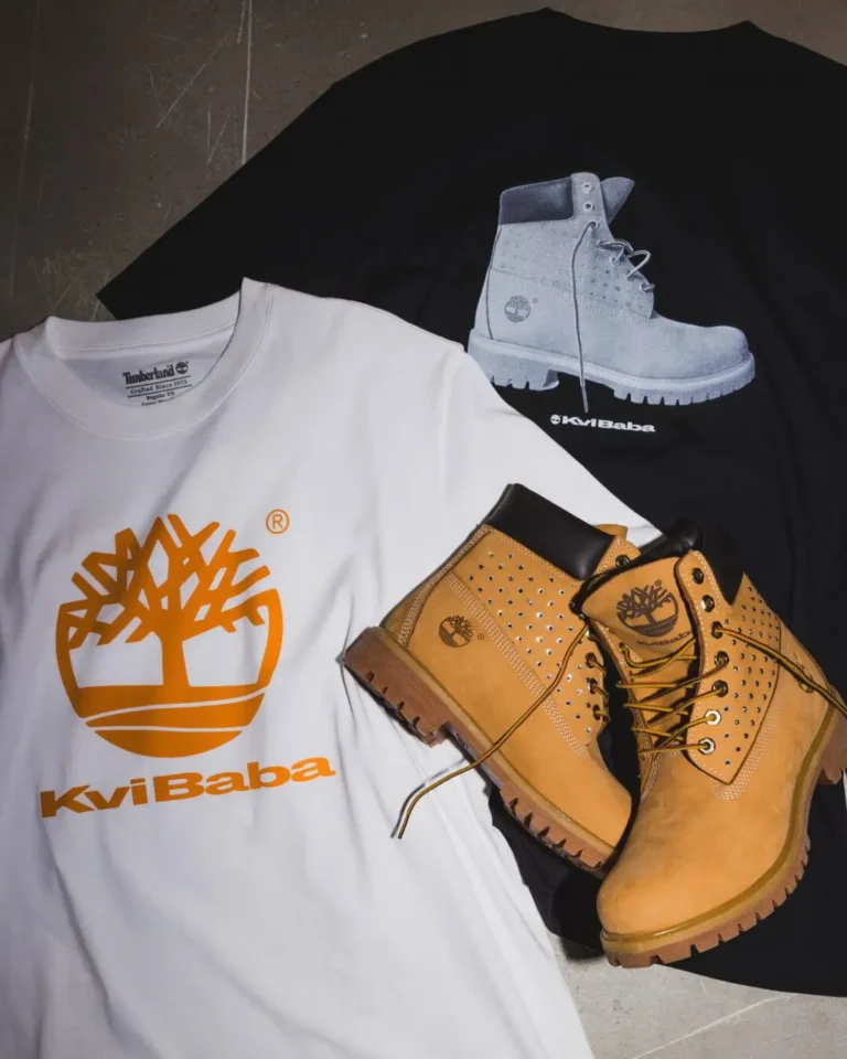 White Timberland x Kvi Baba T-shirt beside wheat studded boots and a black boot-print Tee