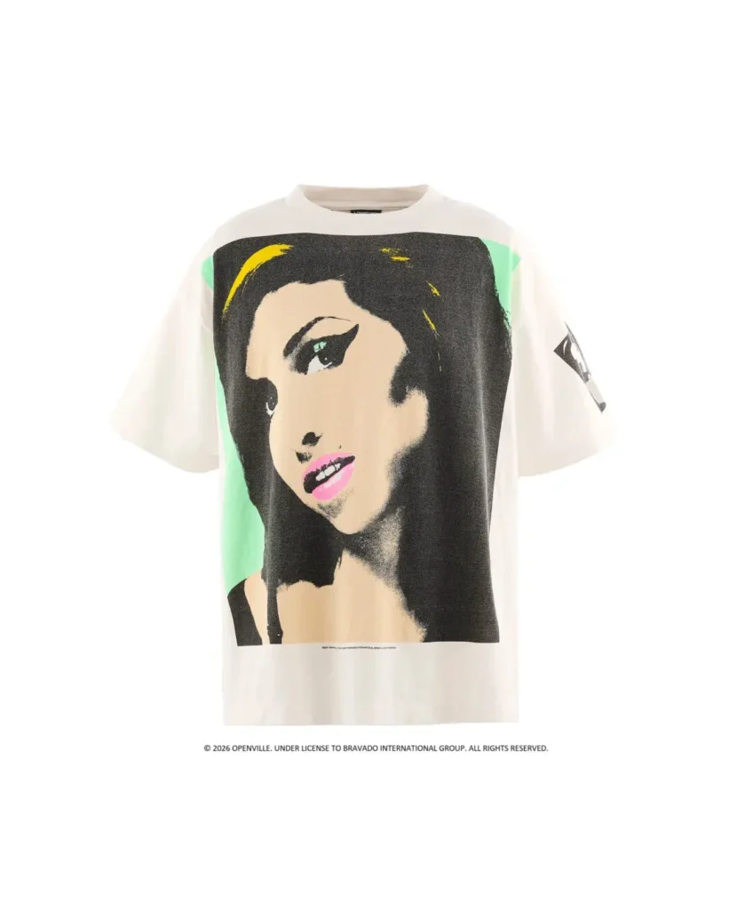 White Amy Winehouse Graphic Tee Feature A Large Pop-Art Portrait With Black, Mint Green, Yellow, And Pink Detail