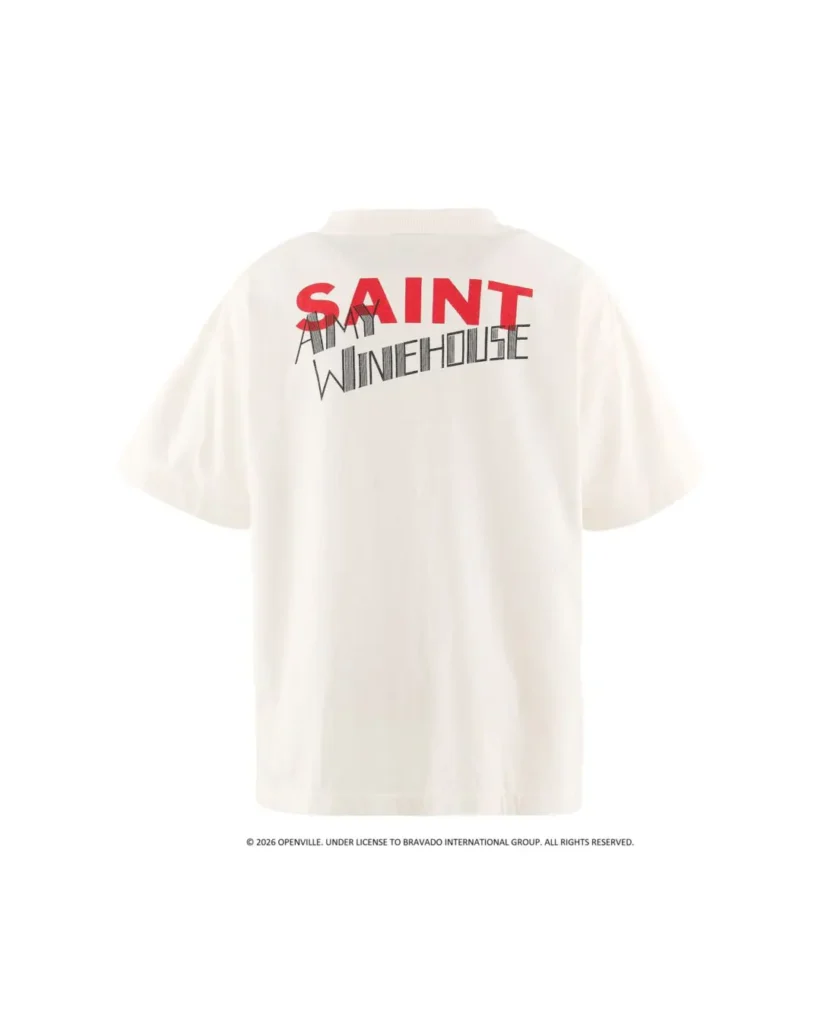 Back View Of White Amy Winehouse Tee Featuring Red “SAINT” Letter Layer With Black “Amy Winehouse” Typography