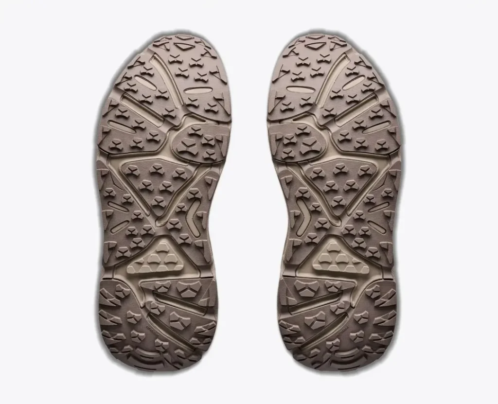 Bottom view of the pair showing the brown rubber outsole with deep multidirectional lugs designed for off-road traction