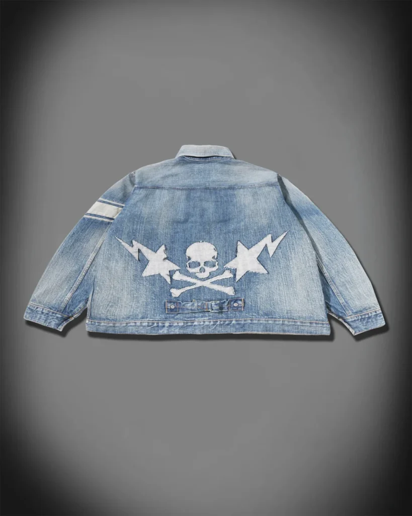 Back product view of the fade denim jacket feature a large skull-and-crossbones, star and lightning appliqué graphic