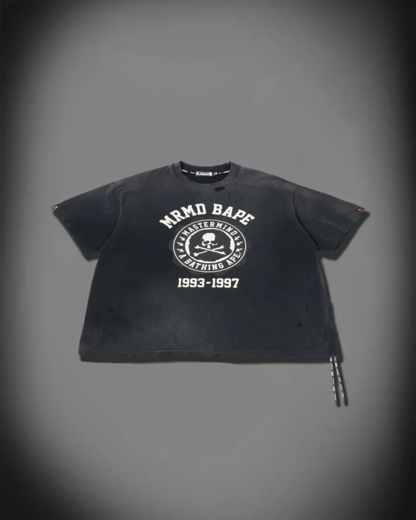 Washed black Mastermind x BAPE Tee with distress detail, central skull-and-crossbones emblem and “1993–1997” graphic