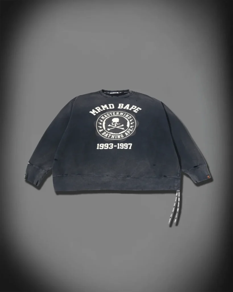 Wash black oversized Mastermind x BAPE sweatshirt with skull emblem, collegiate letter and distress finish