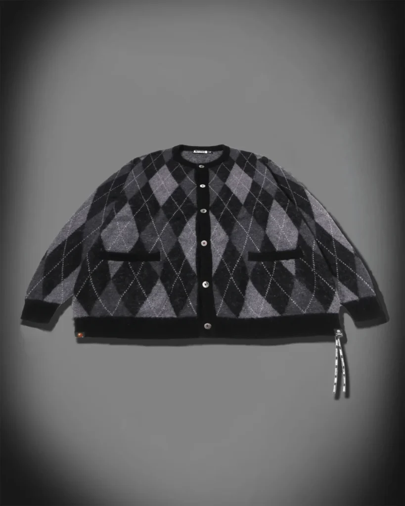 Front product view of a black-and-gray argyle cardigan with button closure, contrast trim and two front pocket
