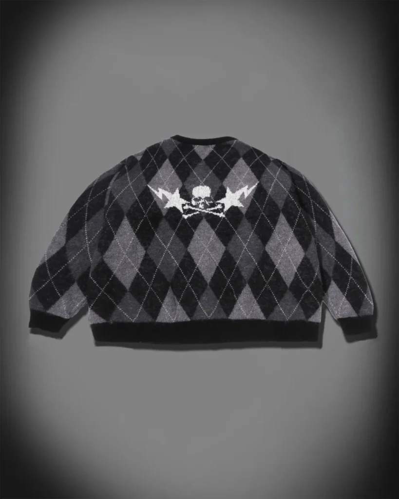 Back product view of the black-and-gray argyle cardigan feature a white skull-and-crossbones graphic with lightning motif