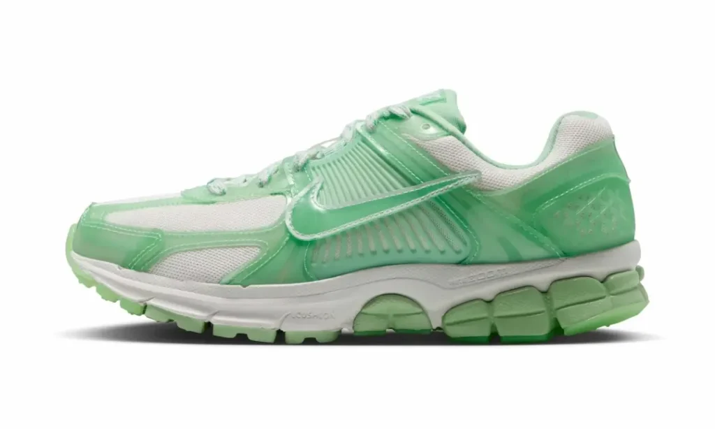 Side profile of the Nike Vomero 5 featuring translucent mint overlays, white mesh underlay, oversized Swoosh, ribbed midfoot cage, and green out