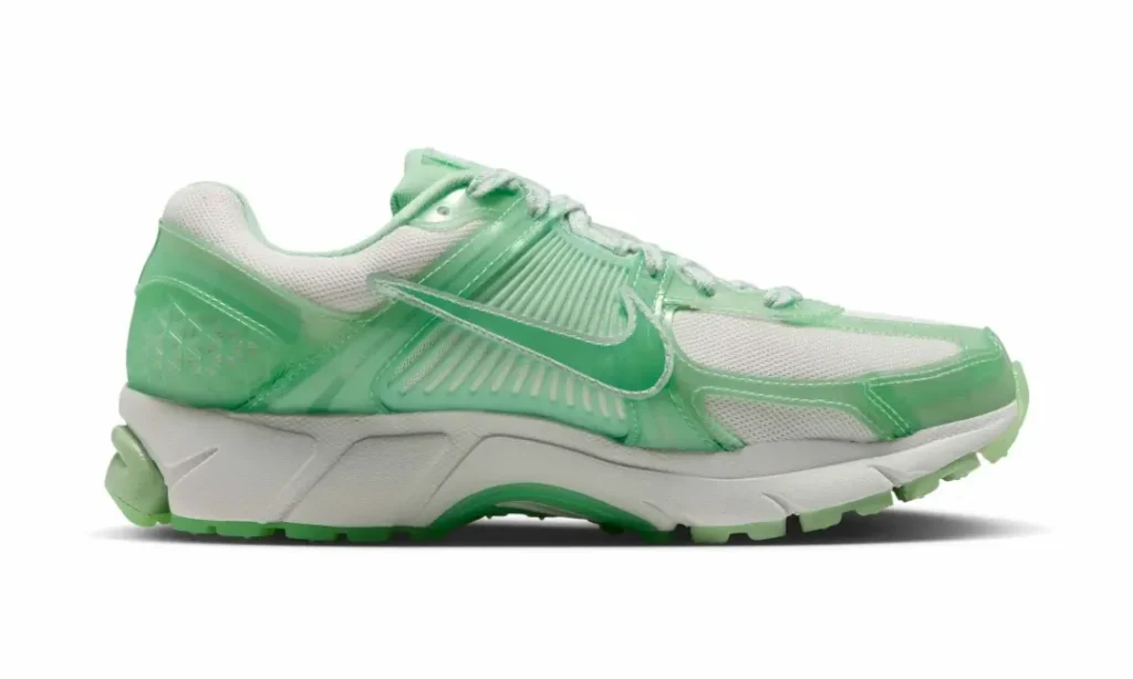 Medial profile of the mint green Nike Vomero 5 highlight translucent overlays, ribbed support structure, white mesh, and sculpt Cushlon mid