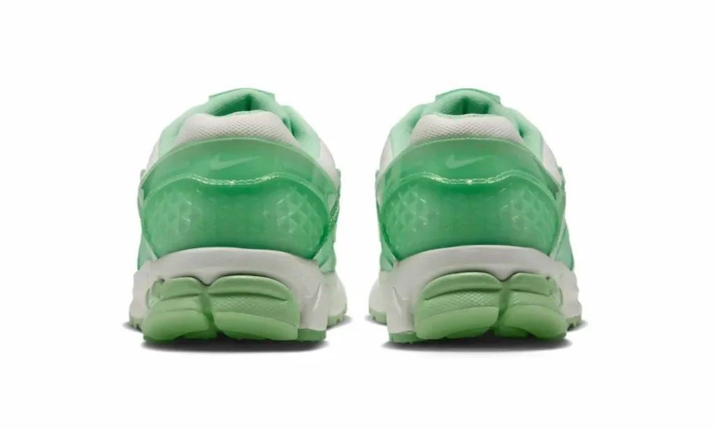 Heel view of the pair feature translucent mint heel counters with geometric texture, white midsoles, and green segment heel cushion