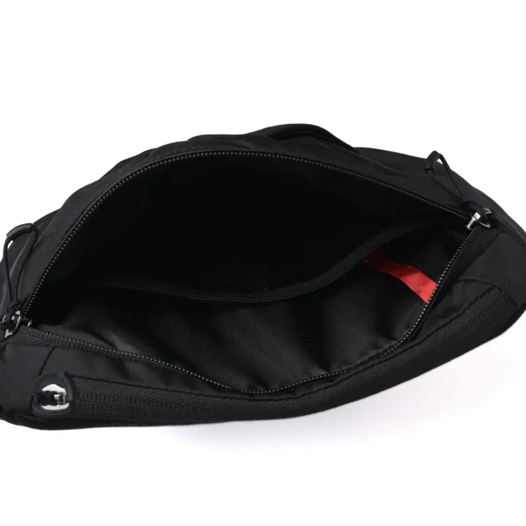 Interior view of the fully opened main compartment revealing a spacious storage area, internal slip pocket, and durable black fabric line