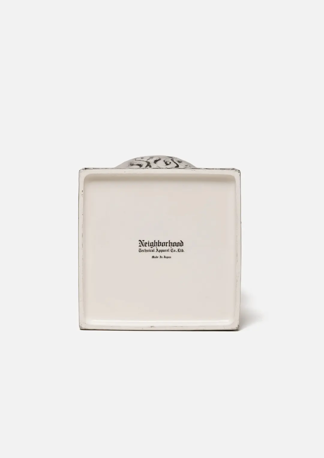 Cream rectangular ceramic incense chamber with a small black Neighborhood logo, viewed from the back