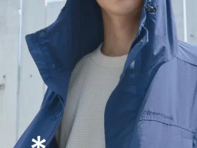 Model wearing a navy Snow Peak hooded jacket over a cream waffle-knit top, with Snow Peak and Urban Research DOORS brand