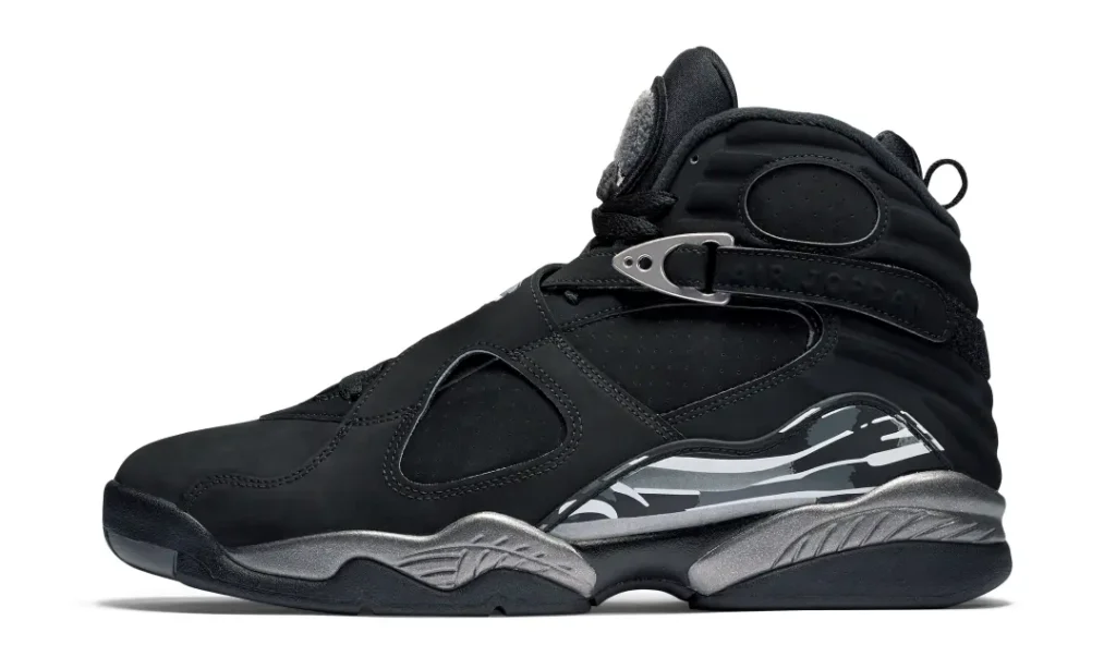 Black high-top Air Jordan 8 sneaker with a silver ankle buckle and metallic gray patterned midsole on white background