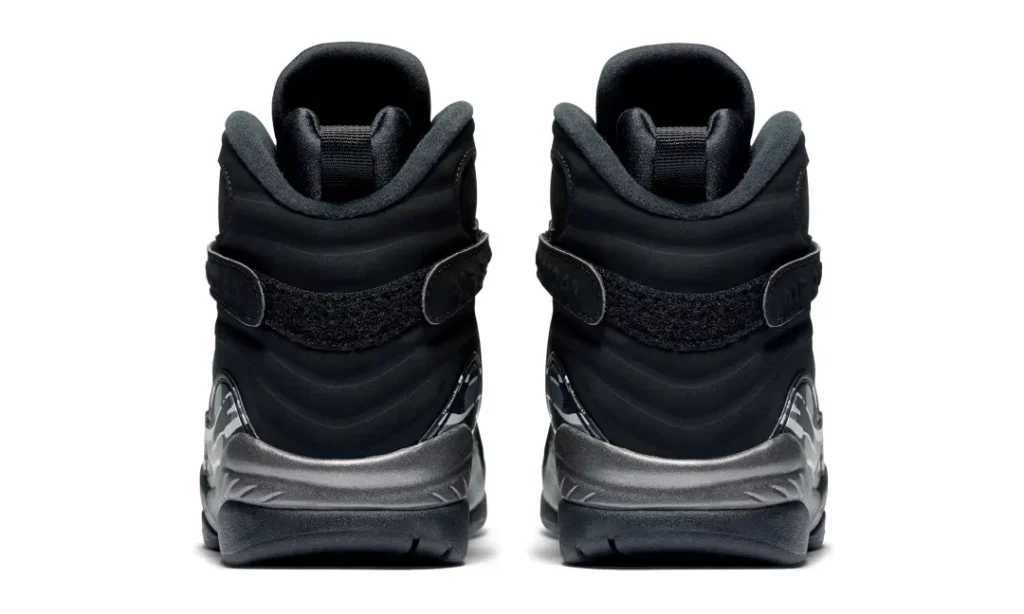 Pair of black Air Jordan 8 sneakers shown from the rear, with gray midsoles and ankle straps on a white background