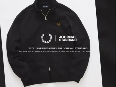 Black Fred Perry zip-up track jacket with gold Laurel Wreath embroidery, presented with JOURNAL STANDARD collide brand