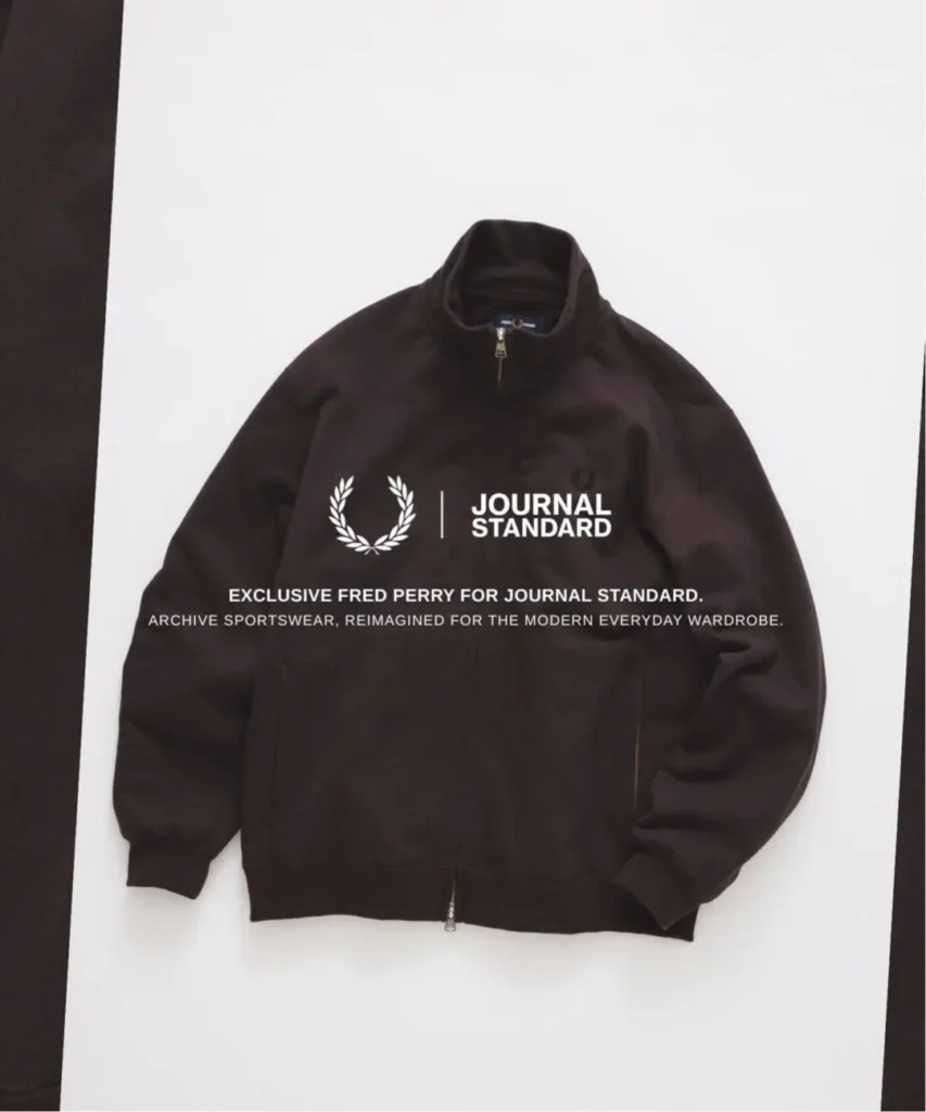 Dark brown Fred Perry zip-up track jacket with tonal Laurel Wreath embroidery, presented with JOURNAL STANDARD collide brand