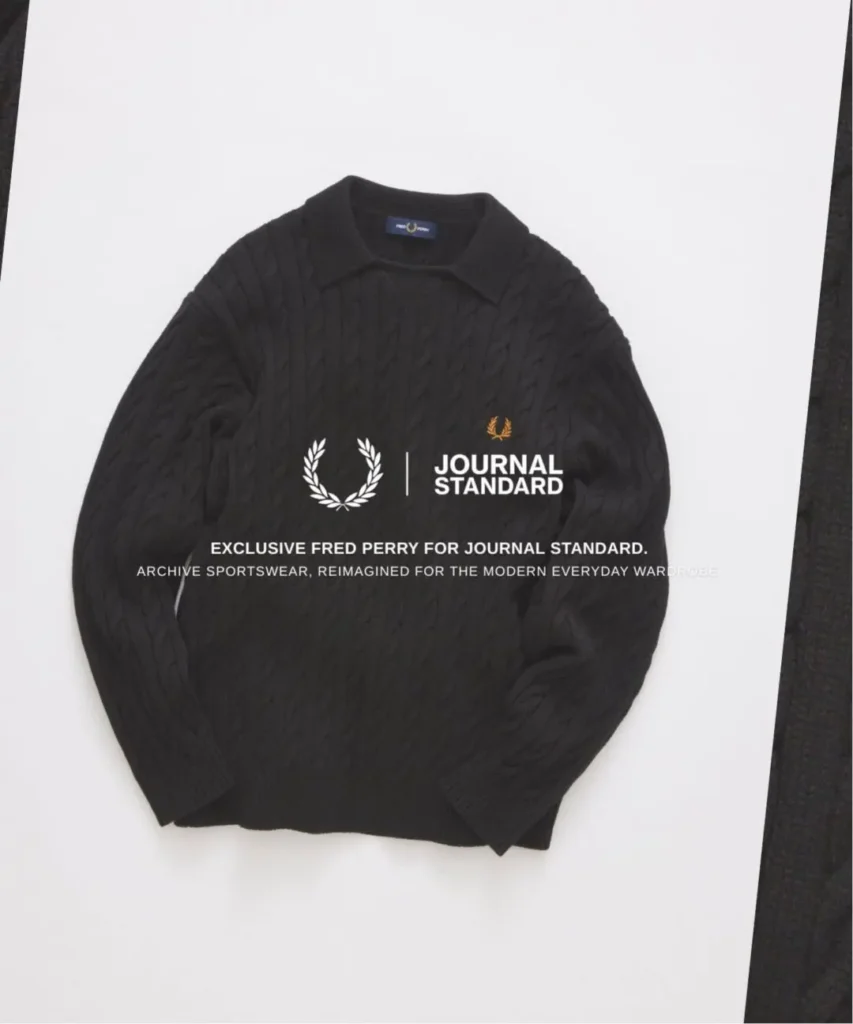 Black Fred Perry cable-knit collared sweater with gold Laurel Wreath embroidery, presented with JOURNAL STANDARD collide brand